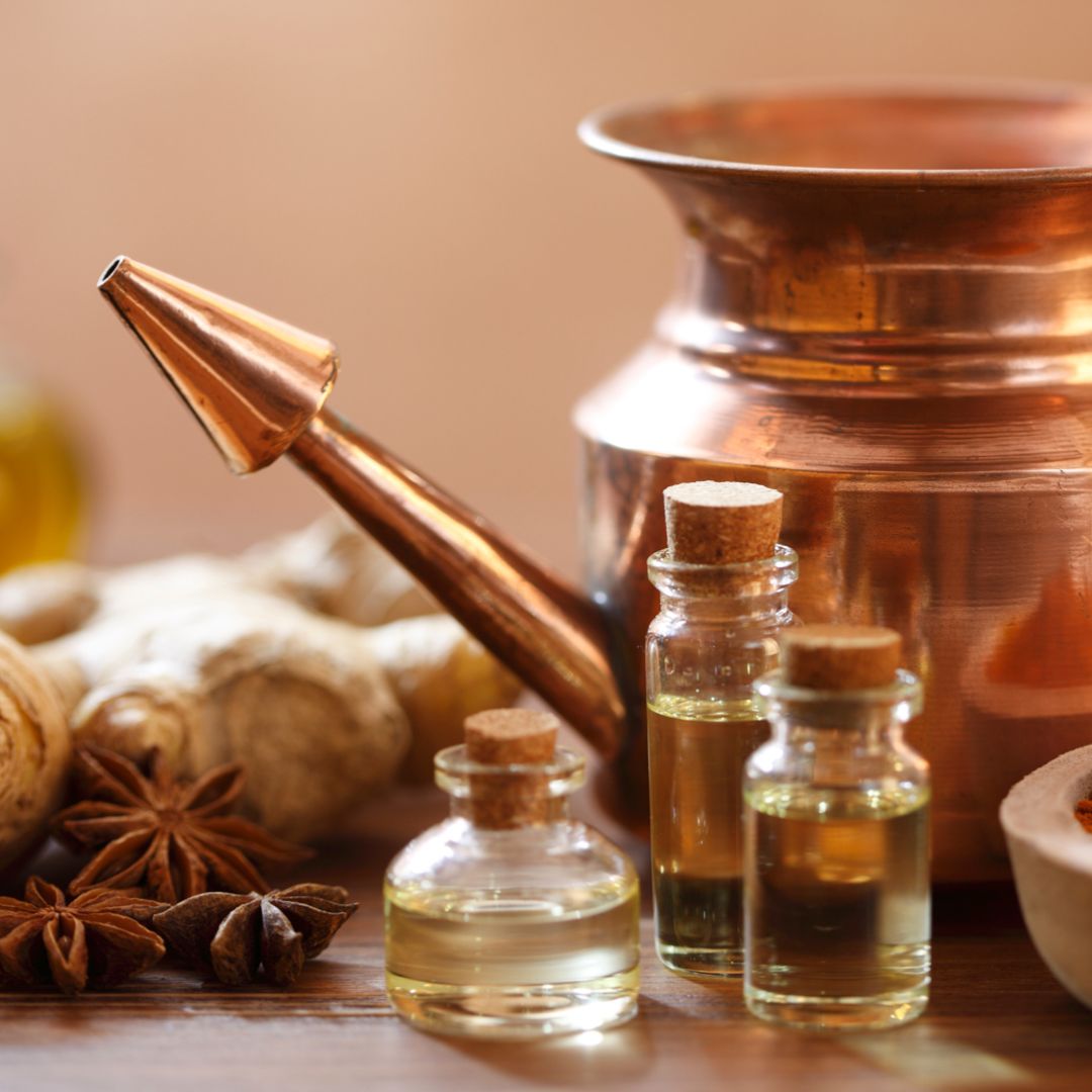 essential oils and glass bottles with ancients and traditional utensils to hold and use oils