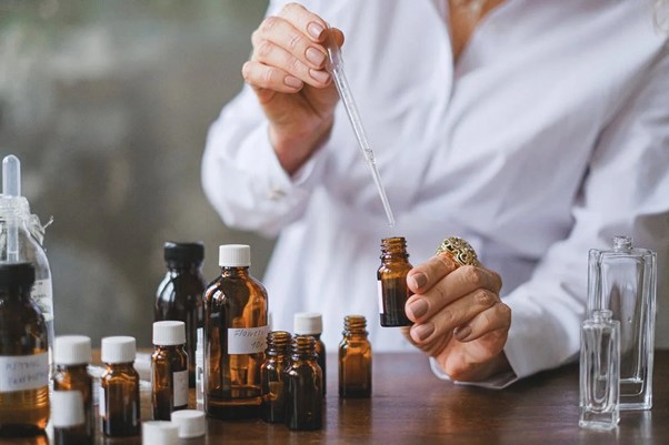 aromatherapist showing essential oils extraction and processing of pure oils