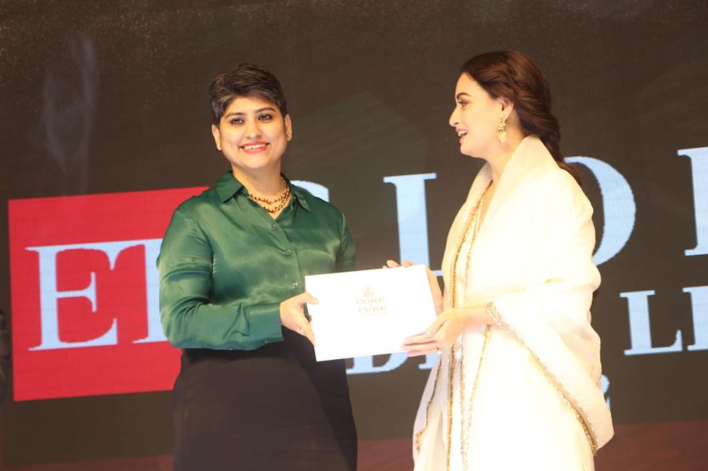 core and pure founder priyanka sachdeva in frame with diya mirza on stage with core & pure gift box