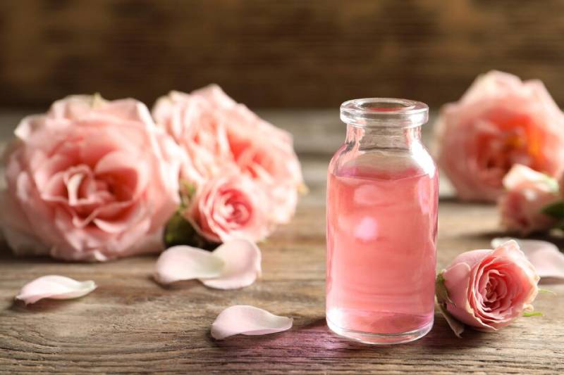 bottle and rose flower showing natural ingredient and hydrosol floral water